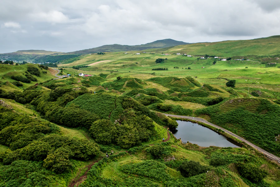Aerial view over the little green hills of the Fairy Glen from Castle Ewen