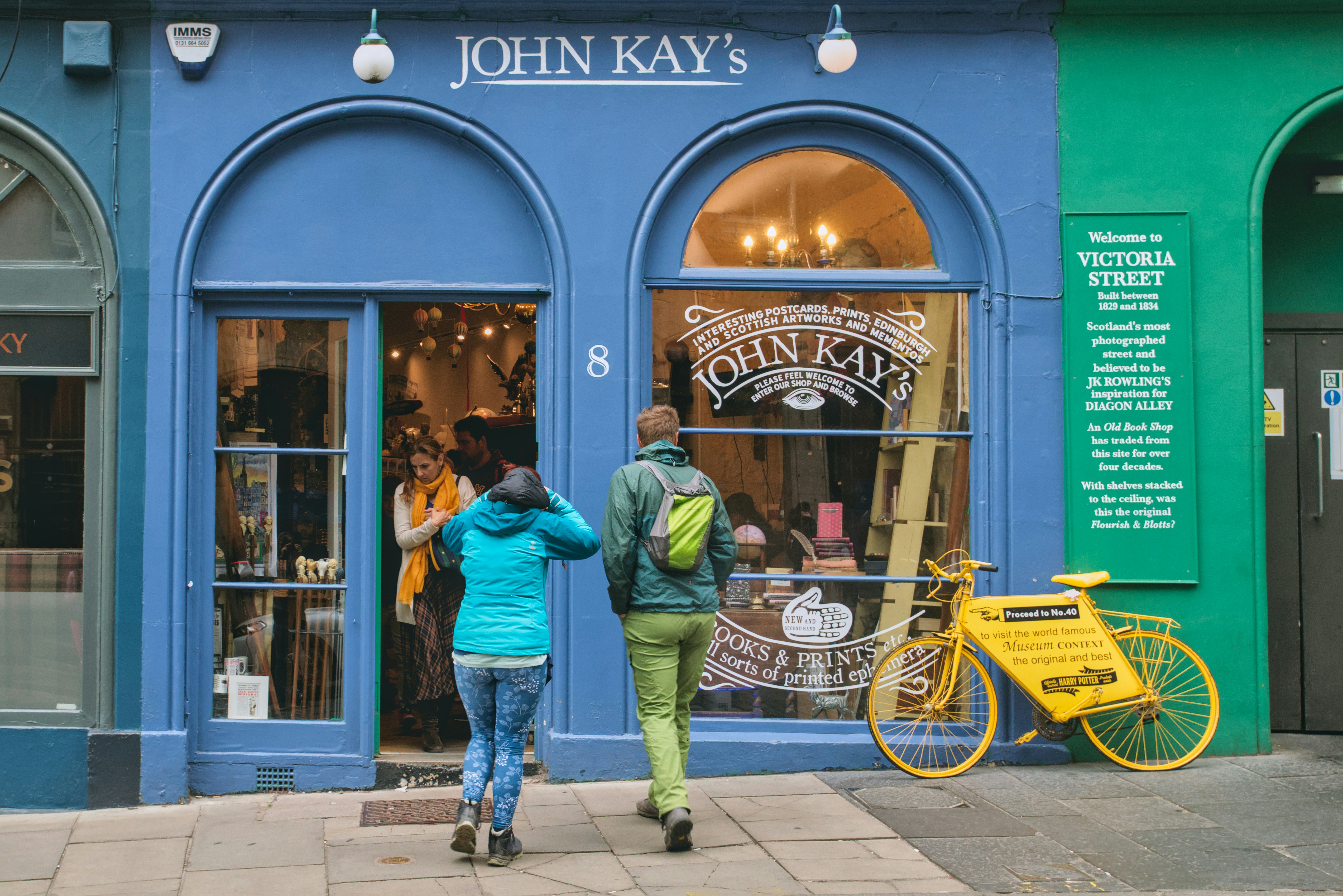 A couple of people that are standing outside of a store