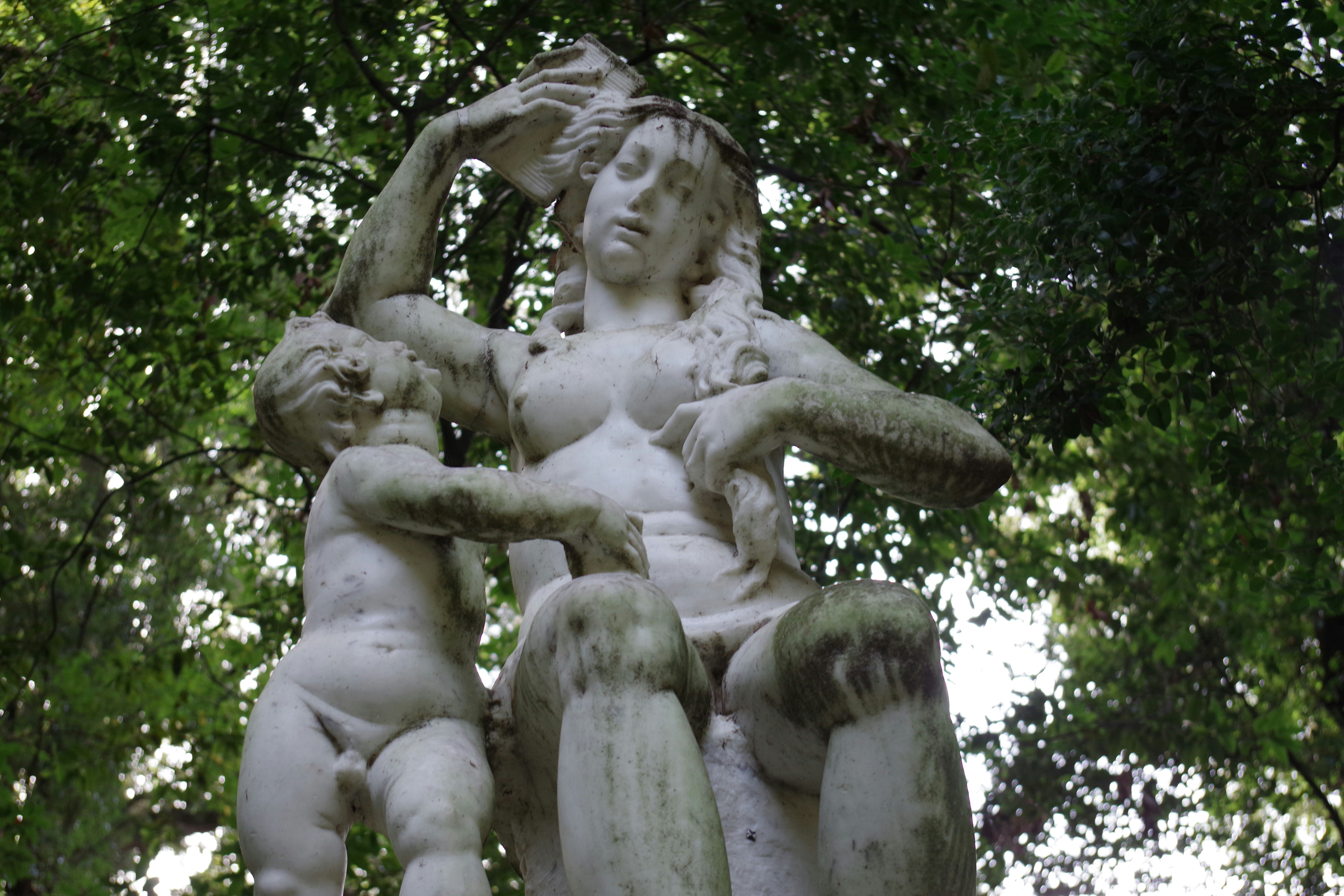 A statue of a woman holding two babies