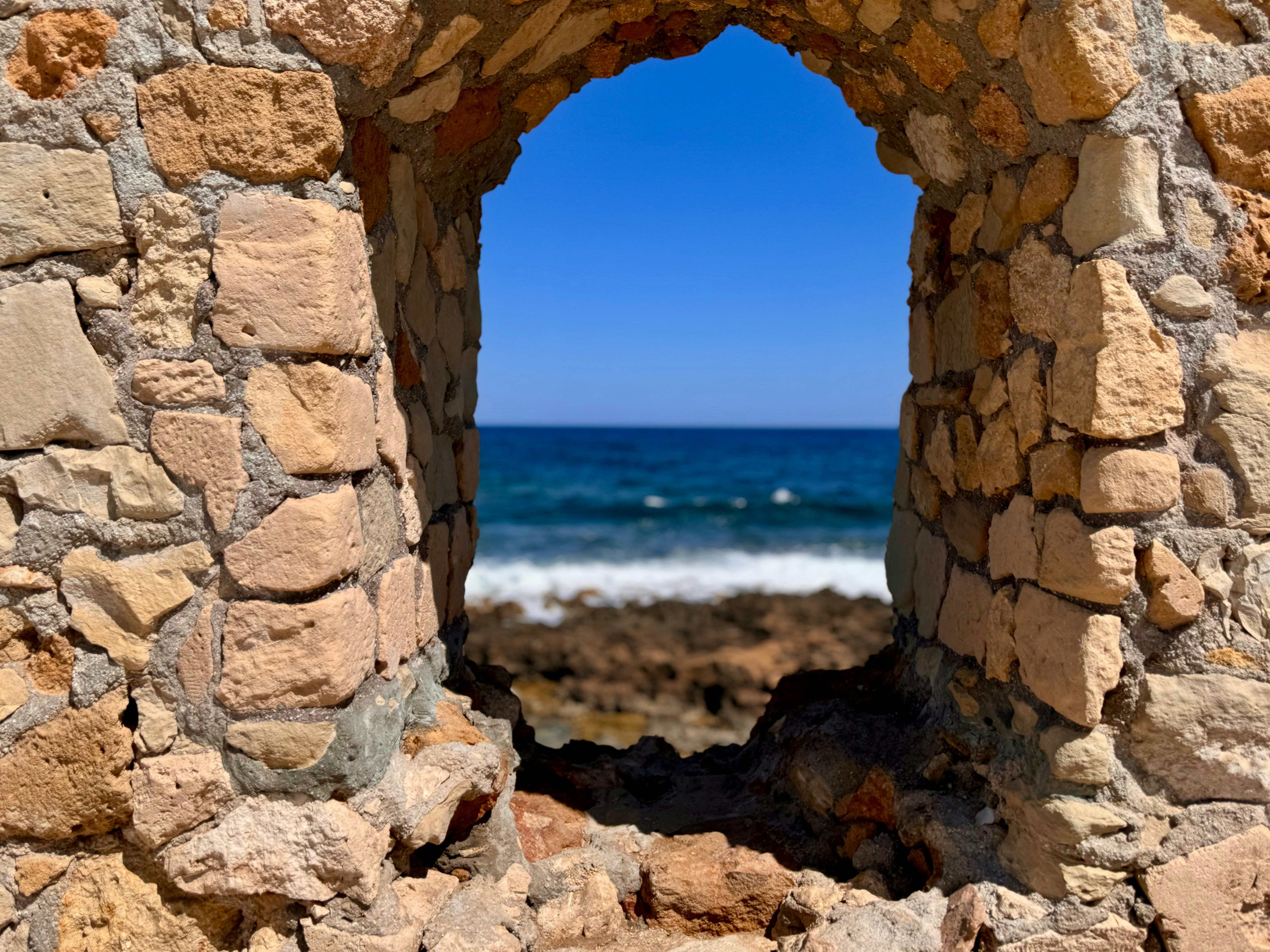 A view of the ocean through a stone window