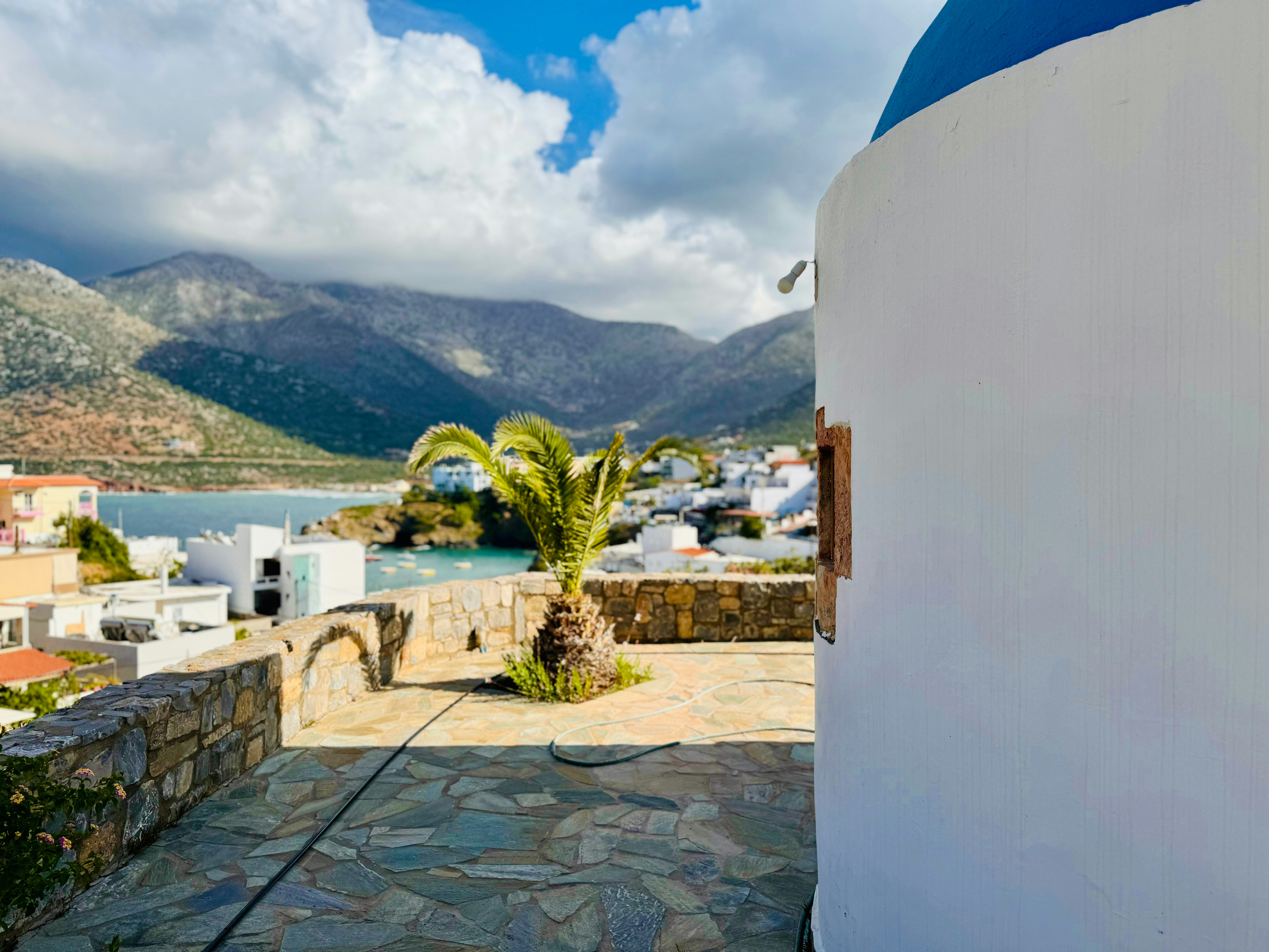 A white and blue building sitting next to a body of water