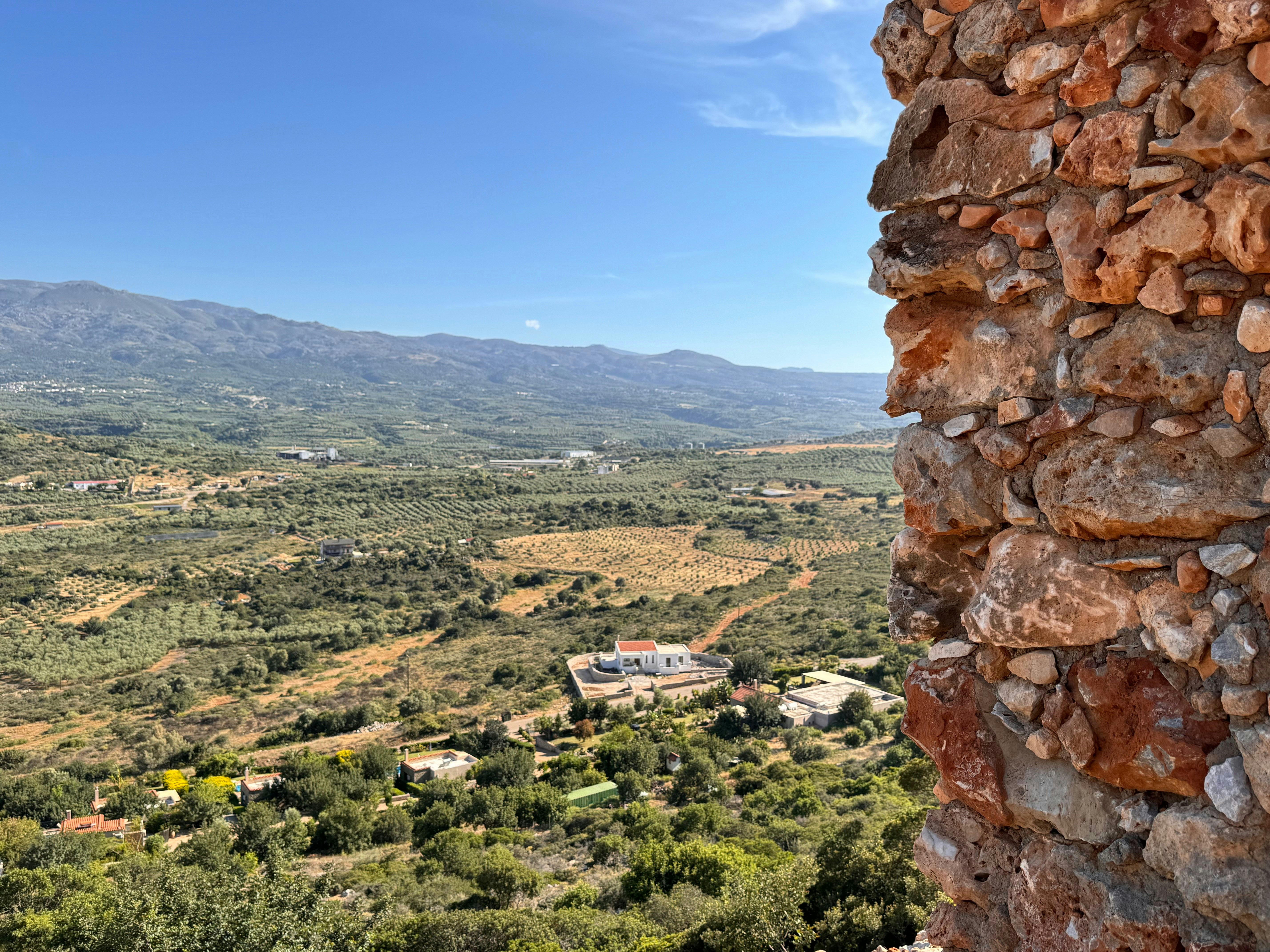 A view of a valley and mountains from a tower