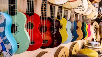 A row of colorful guitars hanging on a wall