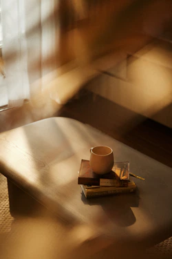A coffee cup sitting on top of a wooden table