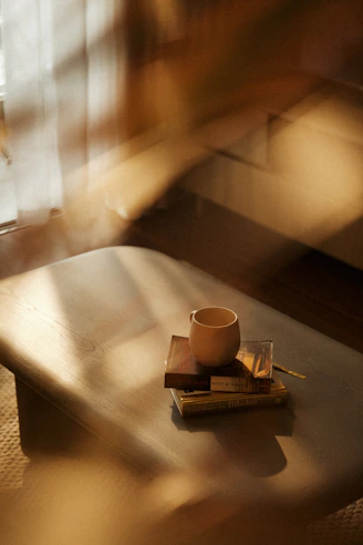 A coffee cup sitting on top of a wooden table