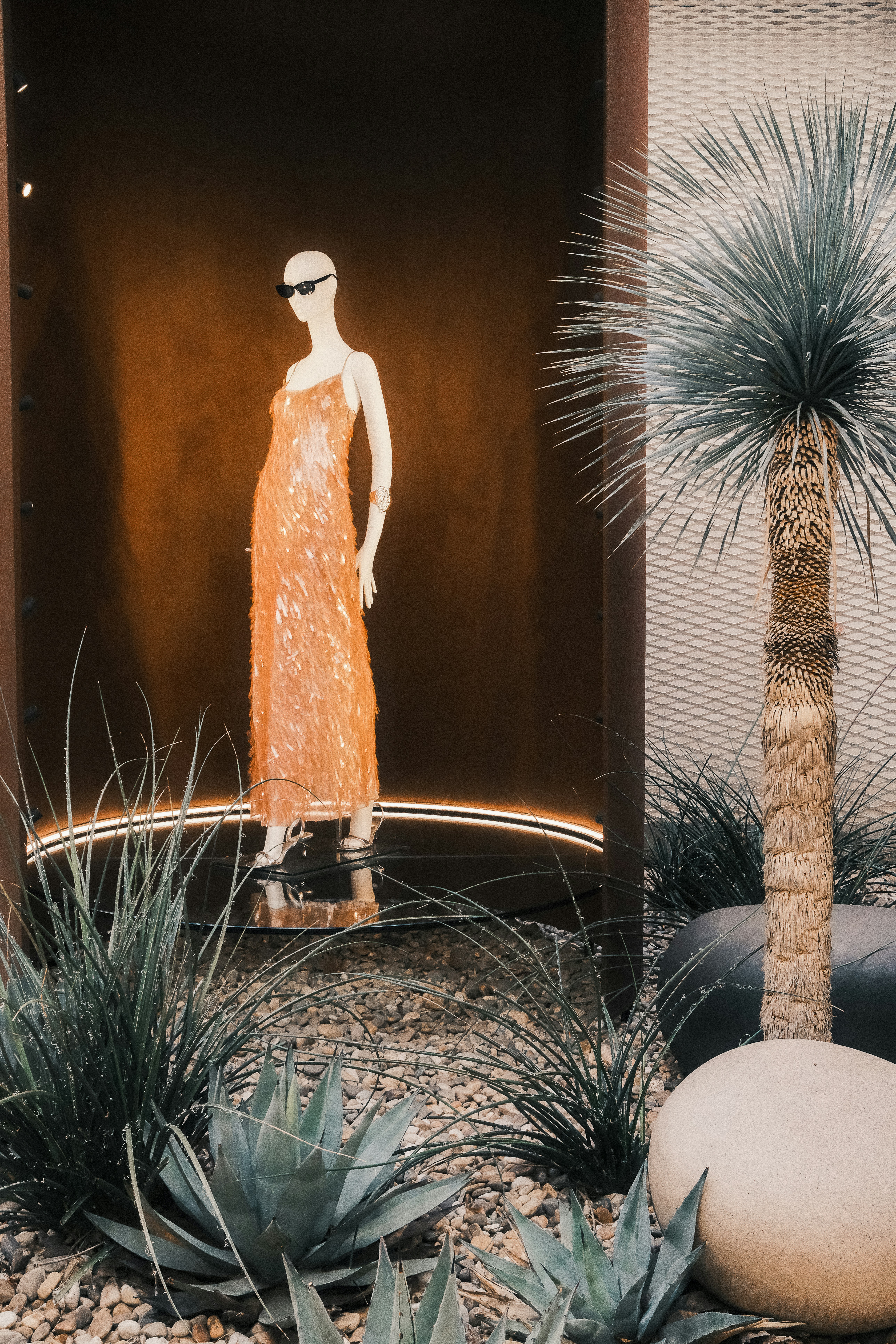 a display of a woman in an orange dress