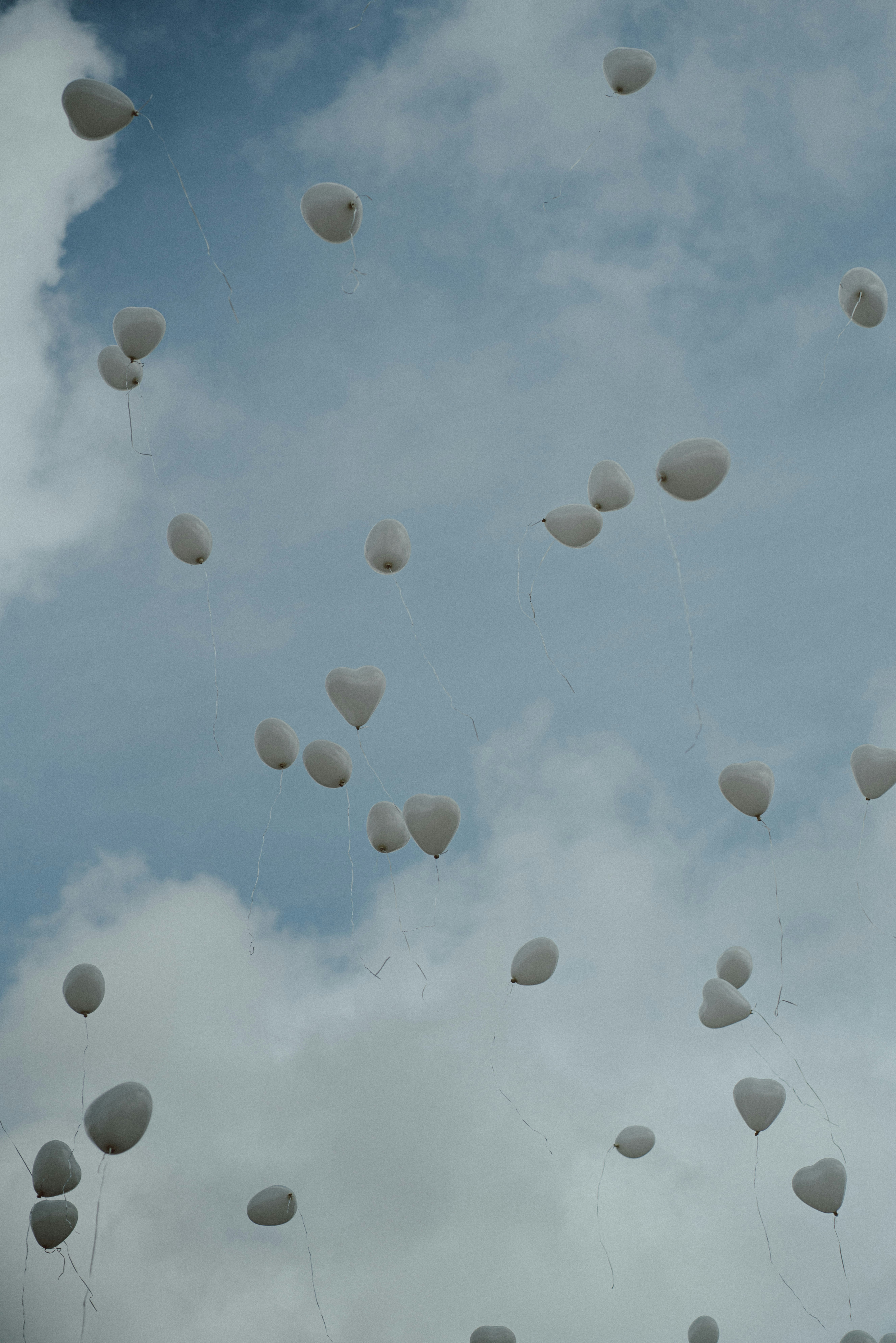 a bunch of balloons floating in the air