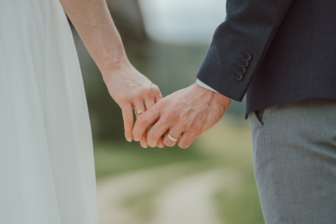 a close up of a person holding the hand of a person