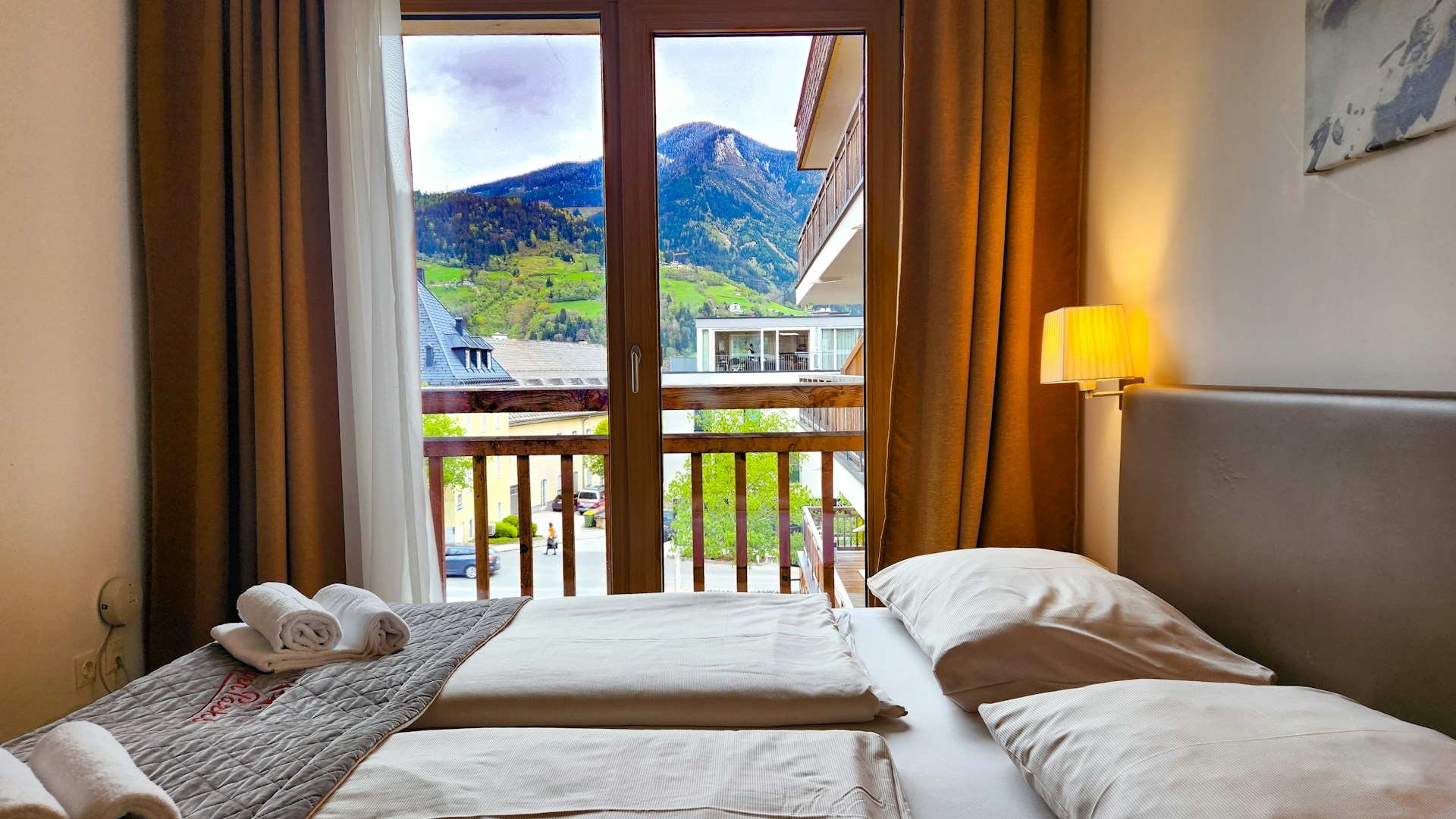 a bedroom with two beds and a balcony