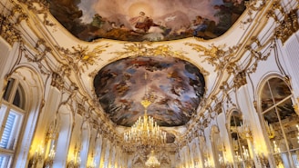 a large room with a chandelier and a painting on the ceiling