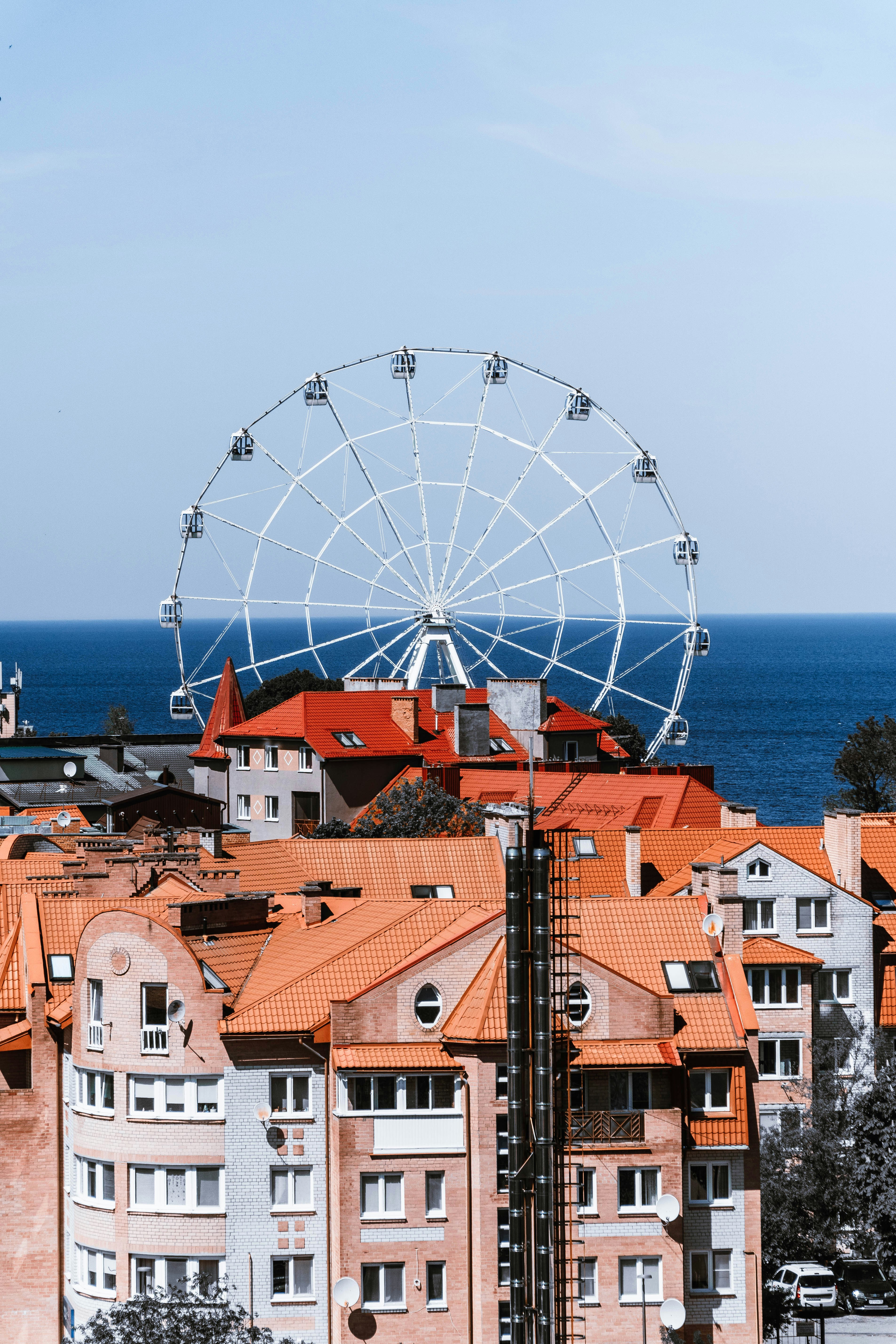 a ferris wheel on top of a building next to the ocean