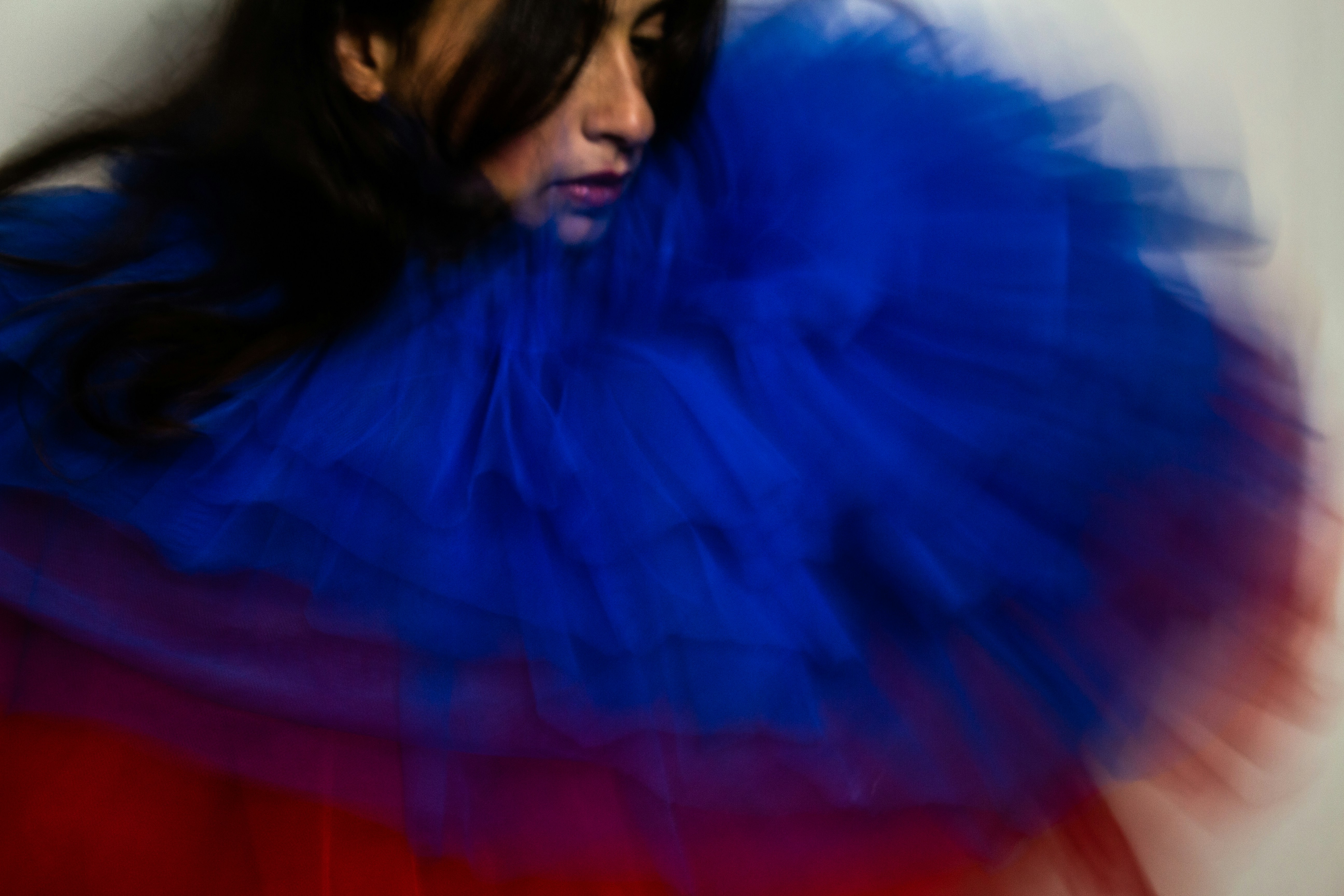 a woman wearing a blue and red dress