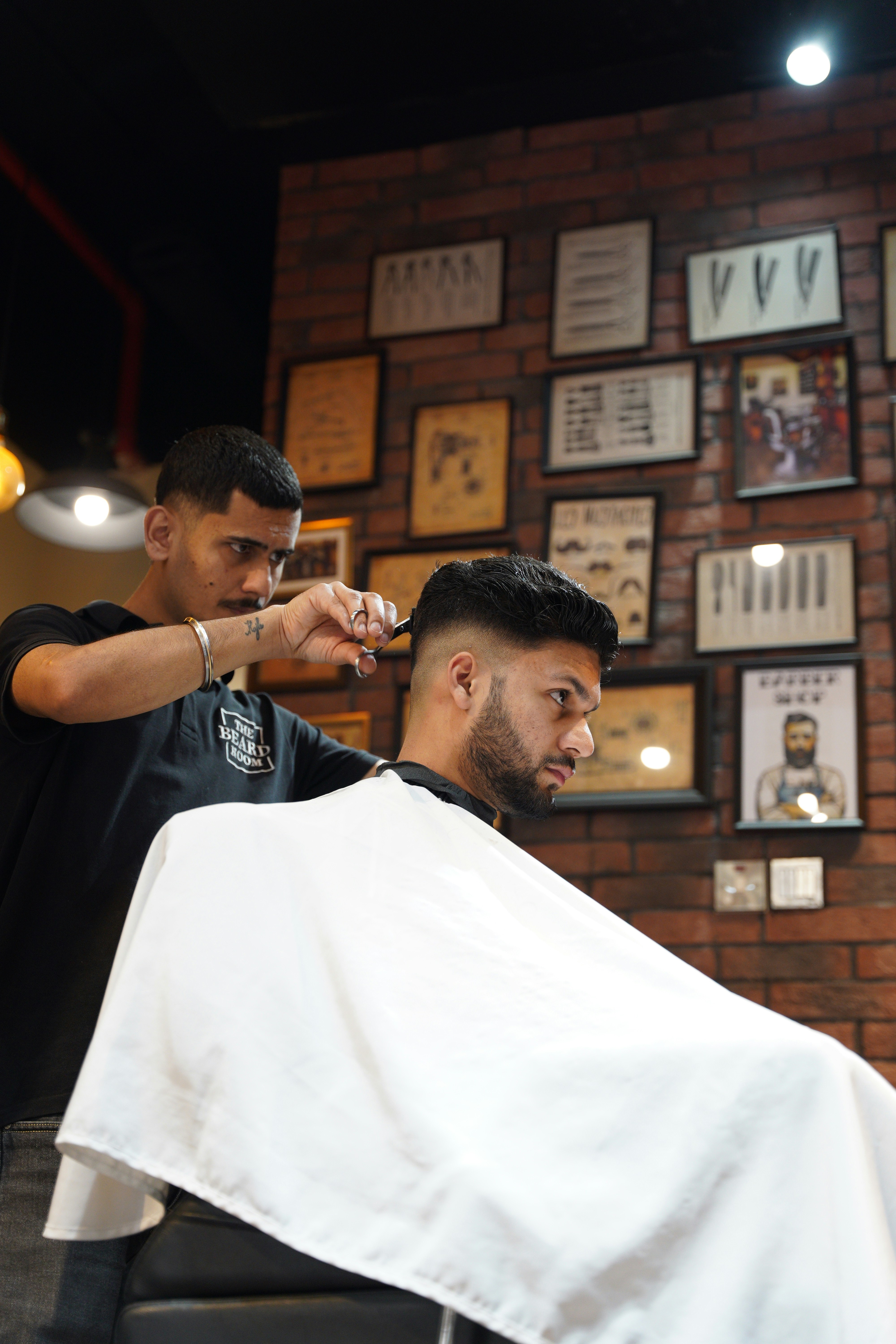 a man getting his hair cut at a barber shop