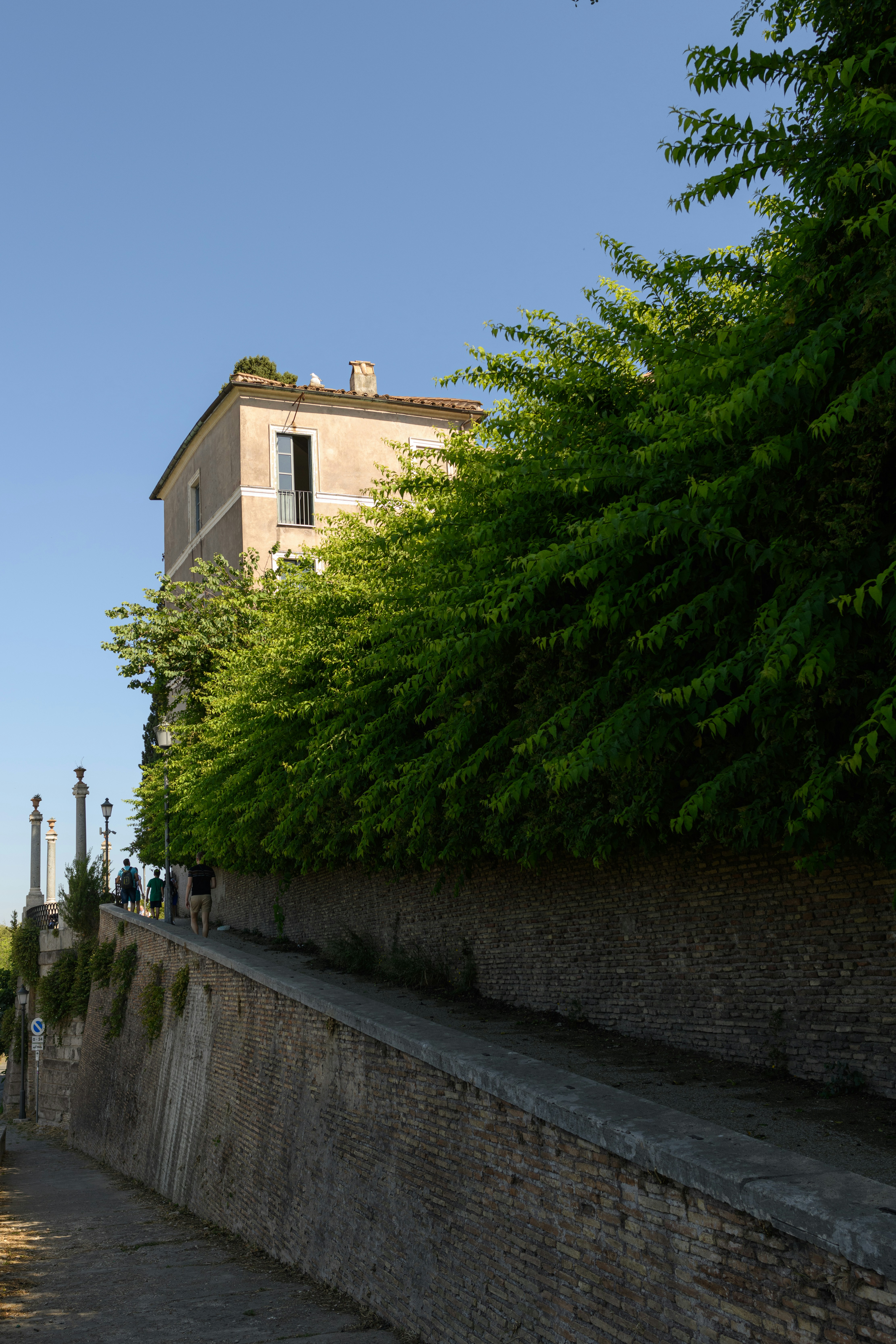 a stone wall with a building in the background