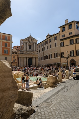 a crowd of people standing around a swimming pool