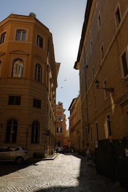 a cobblestone street lined with tall buildings