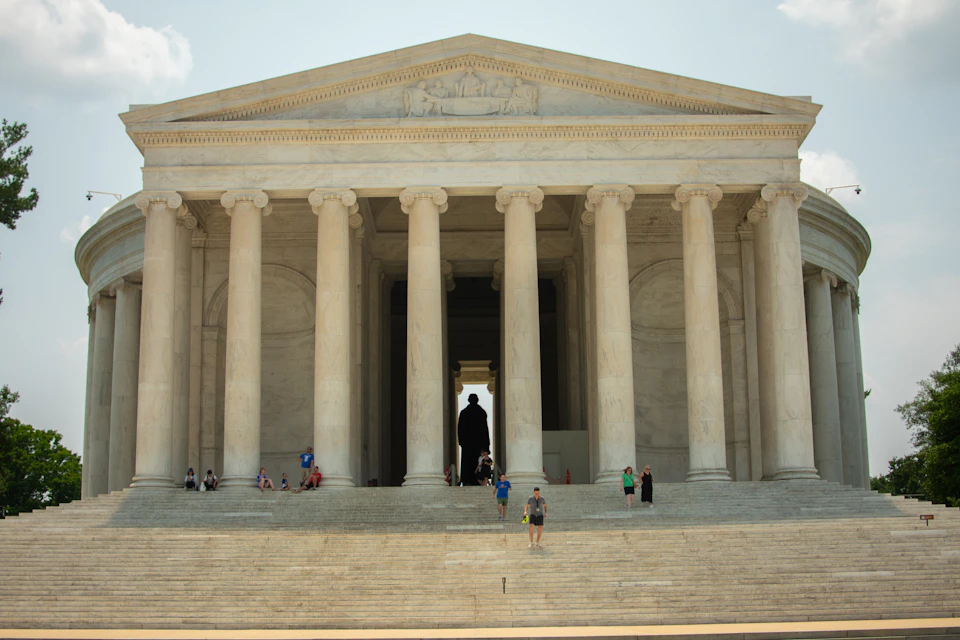 Jefferson Memorial stands tall with grand white stone structure and columns against the sky