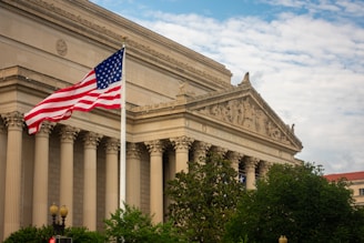an american flag flying in front of a building