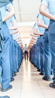 a group of men in blue uniforms standing in a line