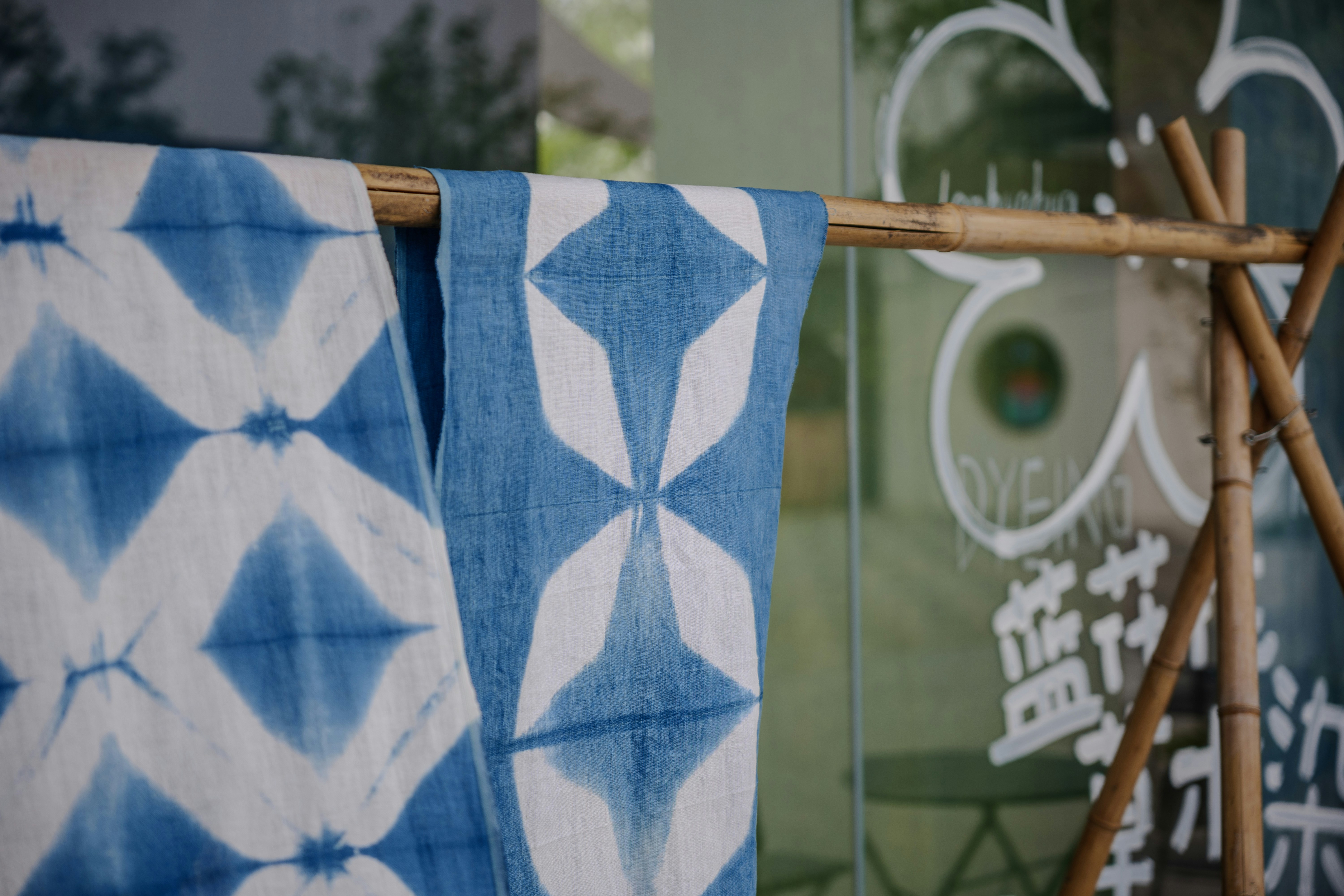 a pair of blue and white towels hanging on a clothes line