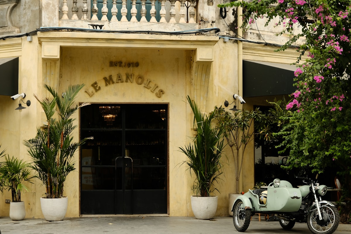Siem Reap Riverside — a French colonial building facade in Siem Reap town, cream rendered walls and ornate balustrade typical of the riverside colonial district