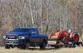 a blue pickup truck with flatbed trailer