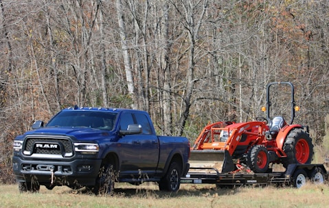 a blue pickup truck with flatbed trailer