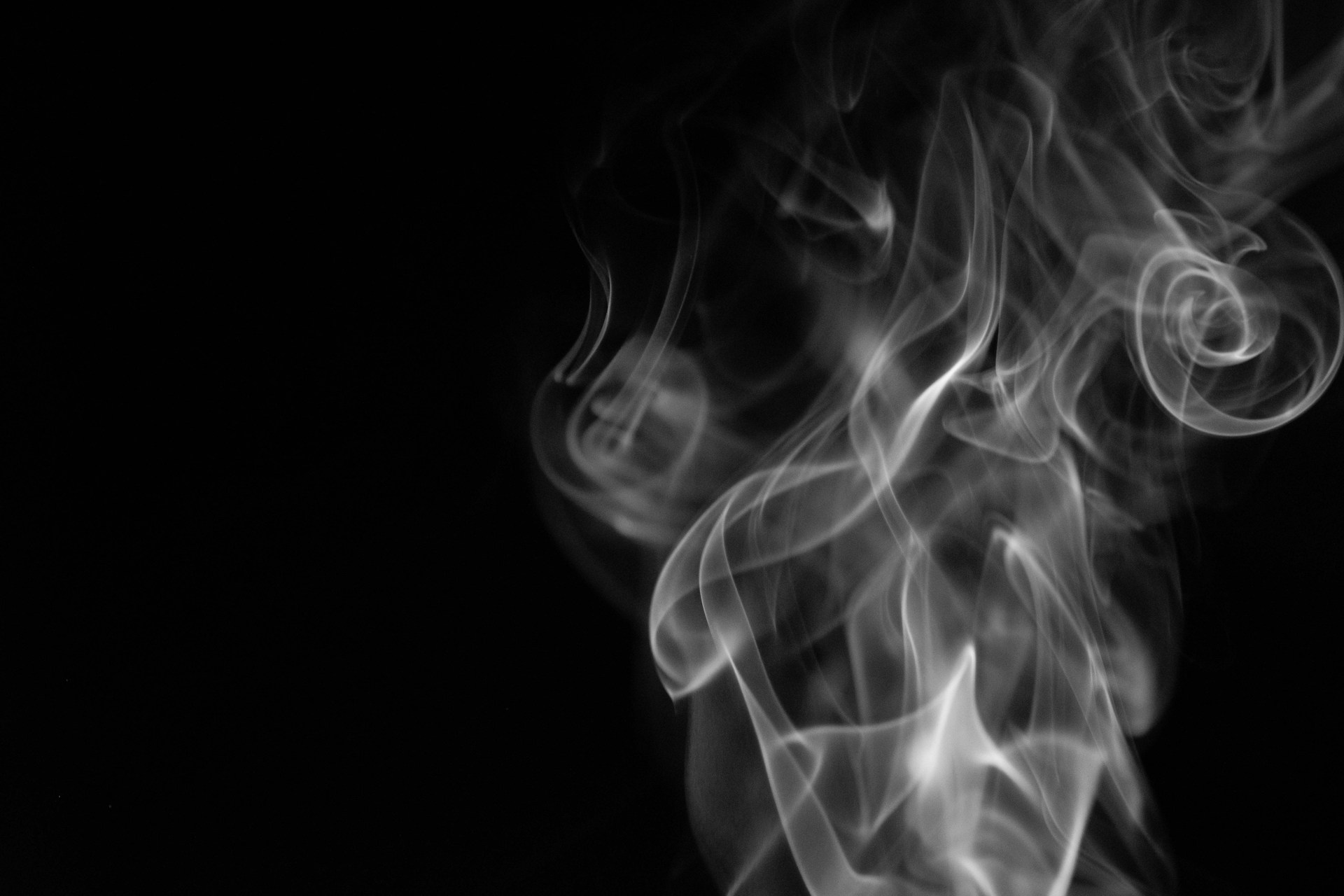 a black and white photo of smoke on a black background