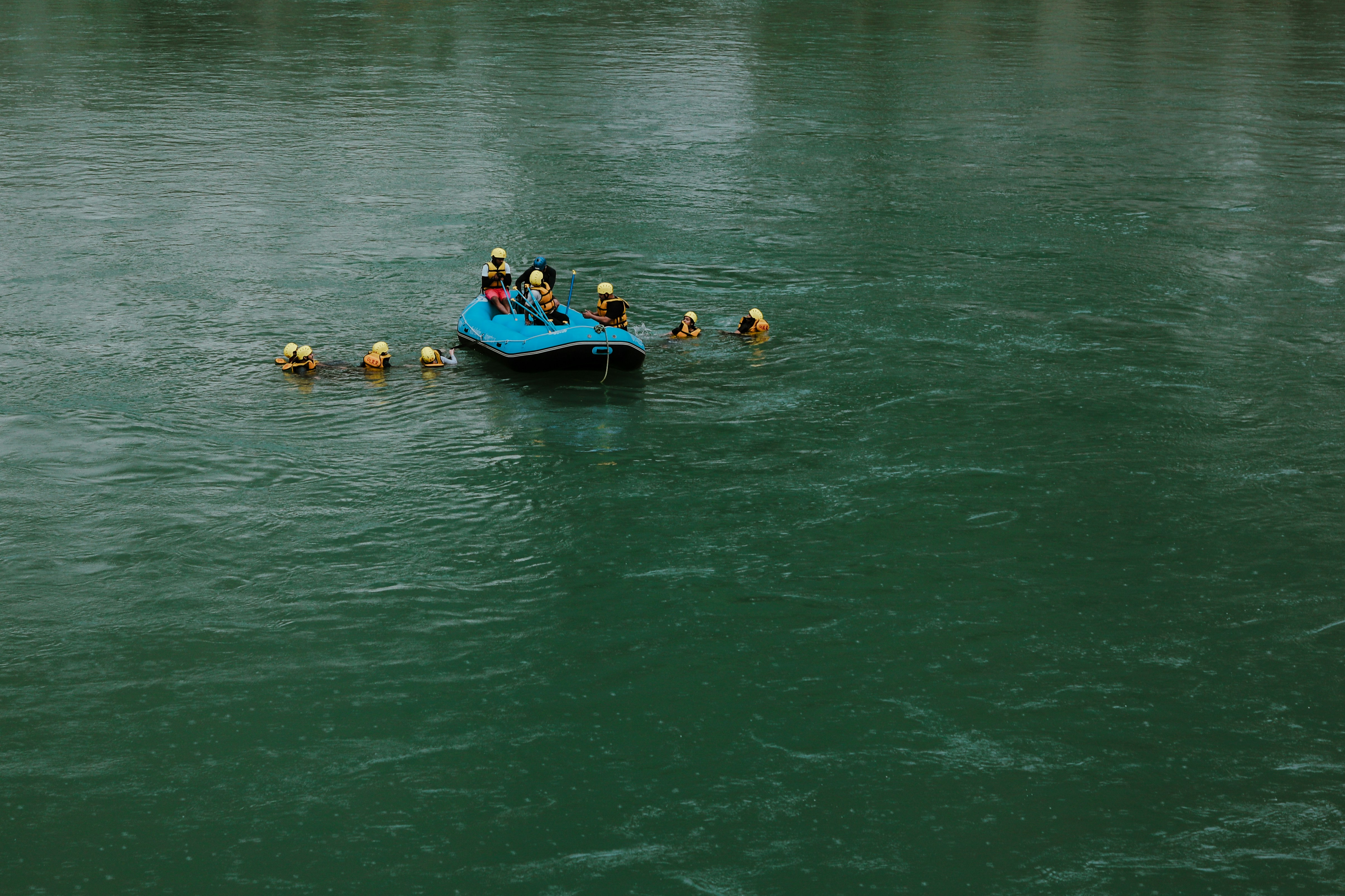 a group of people in a small boat on a body of water