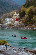 a group of people in canoes paddling down a river