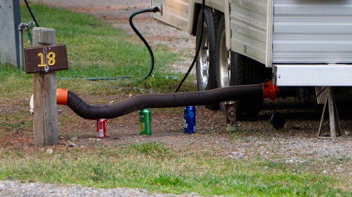 a hose connected to a mailbox in front of a trailer