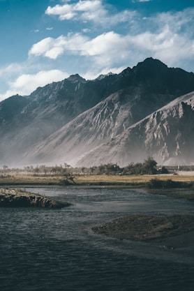 a river running through a lush green valley
