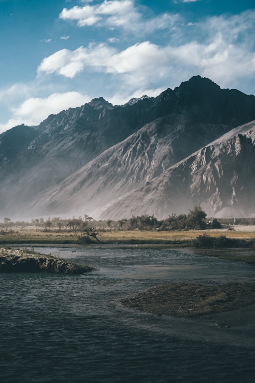 a river running through a lush green valley