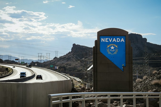 Open highway with a Nevada road sign, the kind of drive many Las Vegas families take during the Nevada Day long weekend