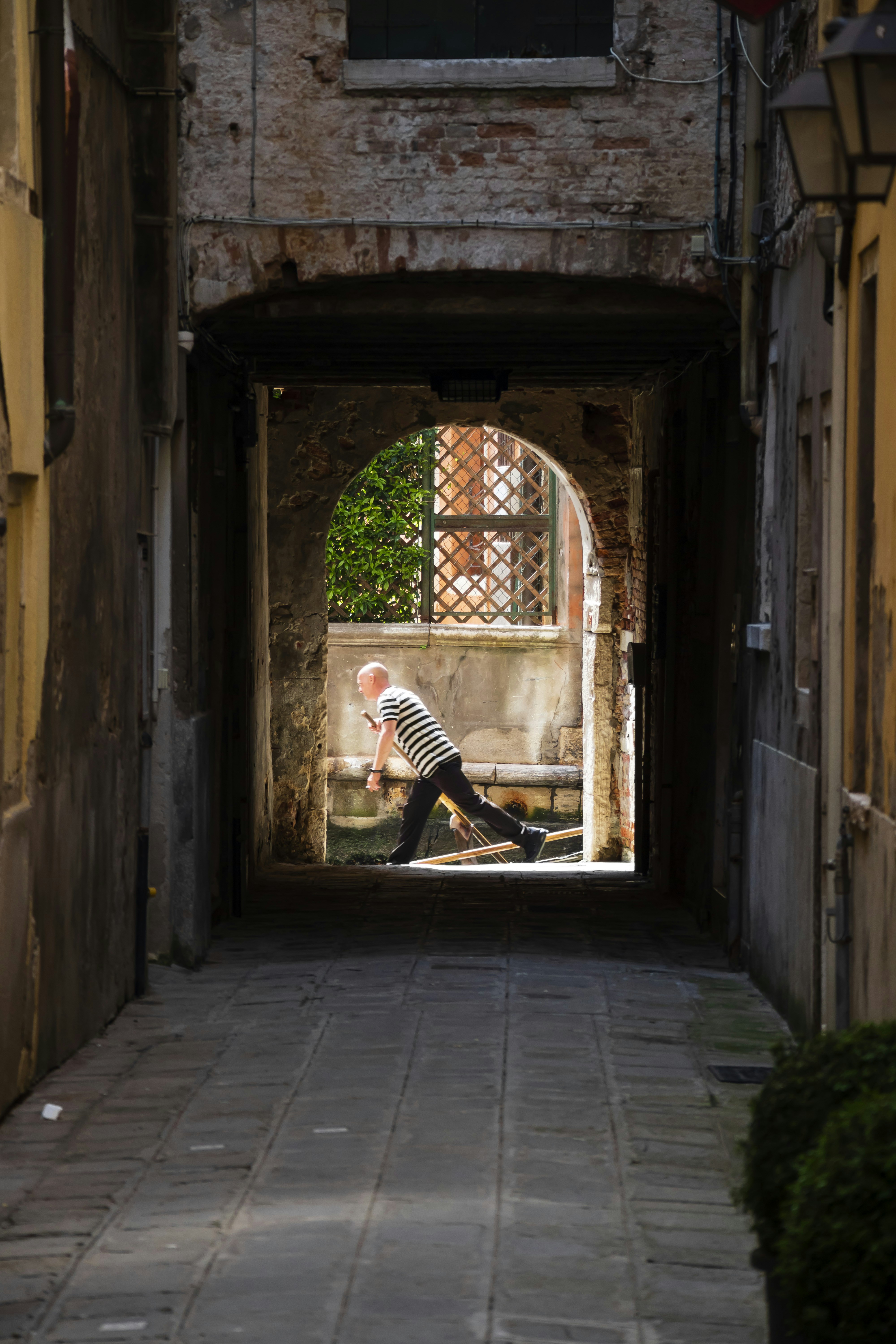 a person sitting on a bench in a tunnel