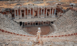 a statue of a woman standing in front of a building