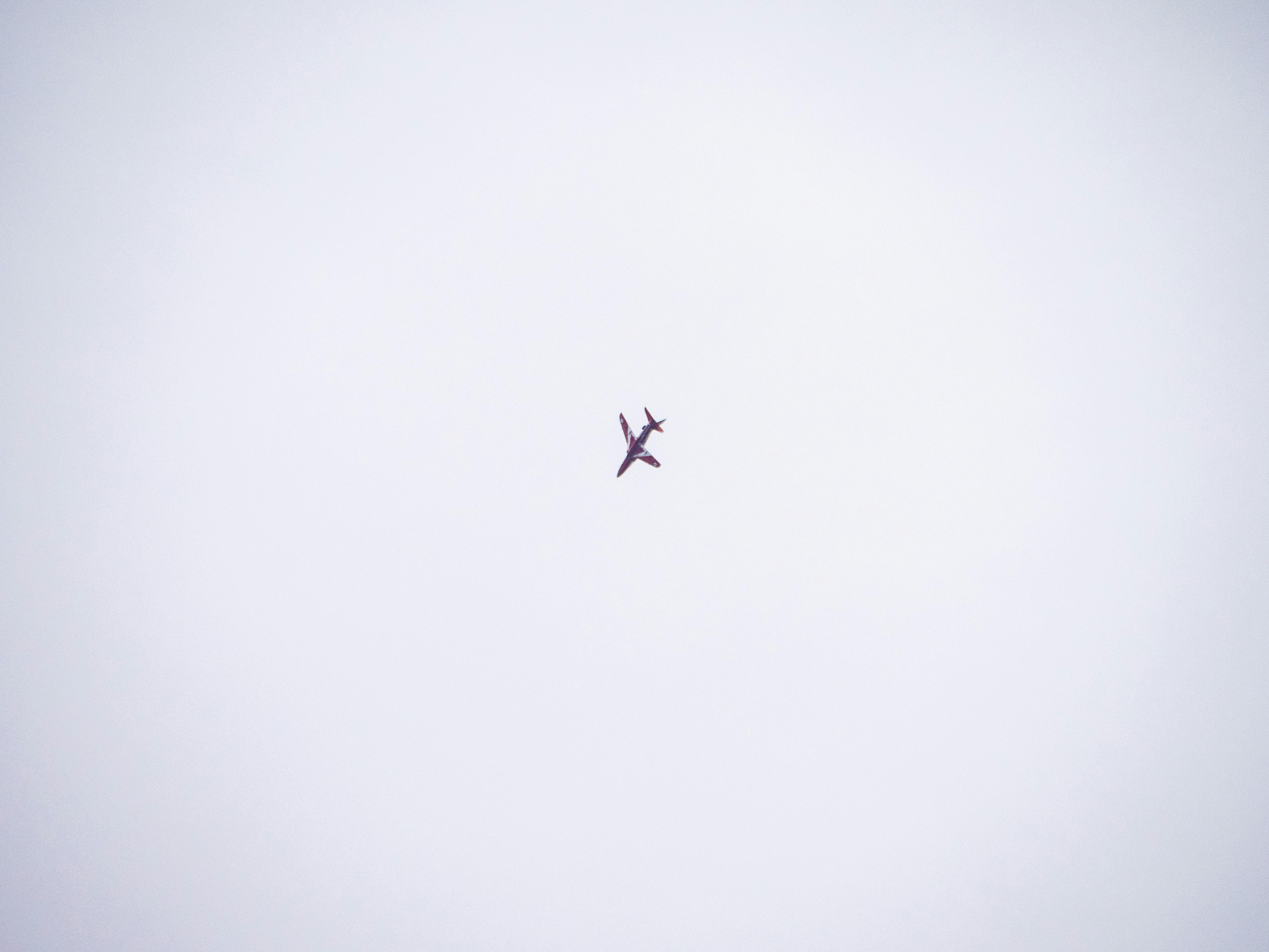 an airplane flying in the sky on a cloudy day