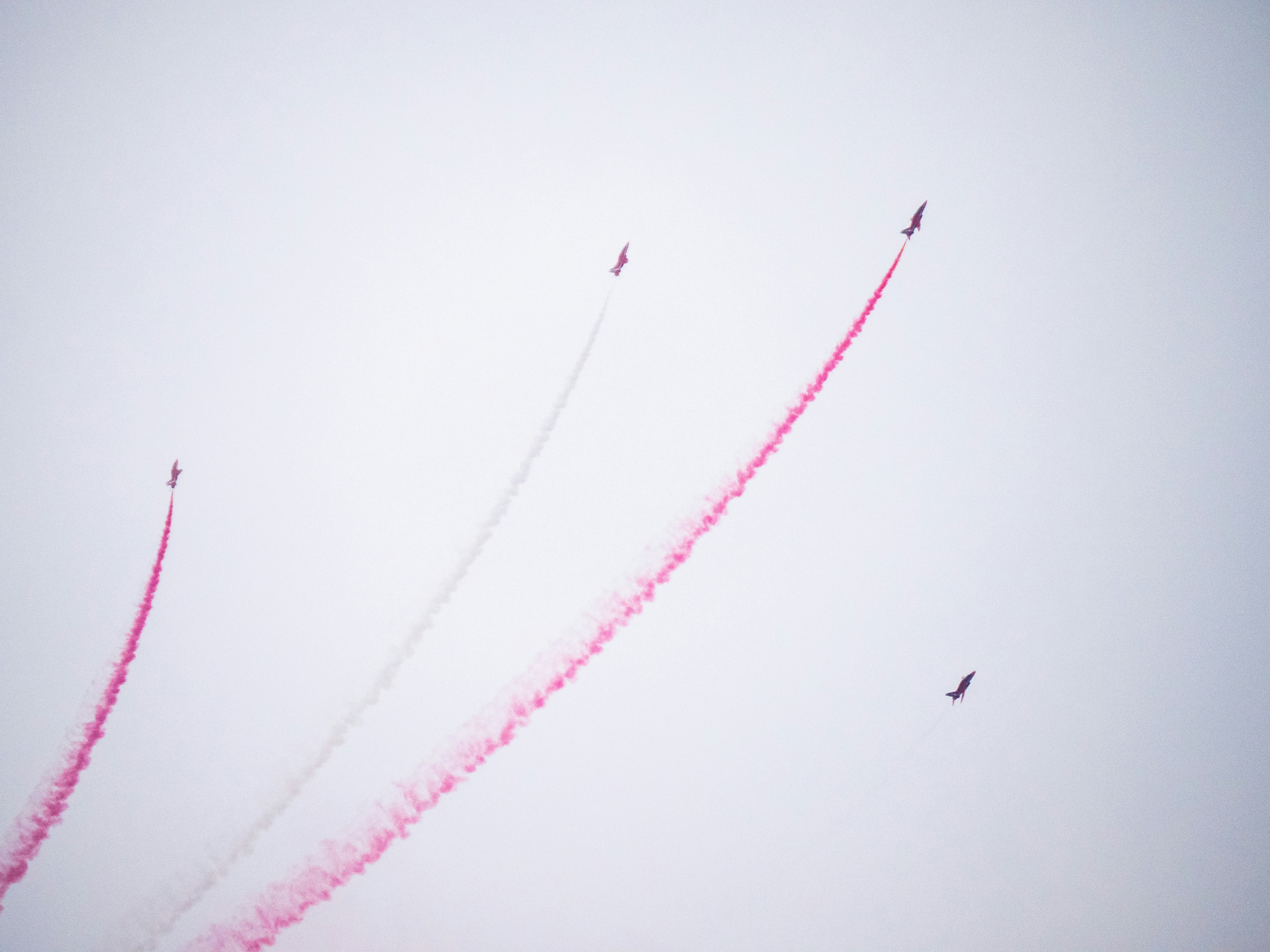 a group of airplanes flying through a cloudy sky