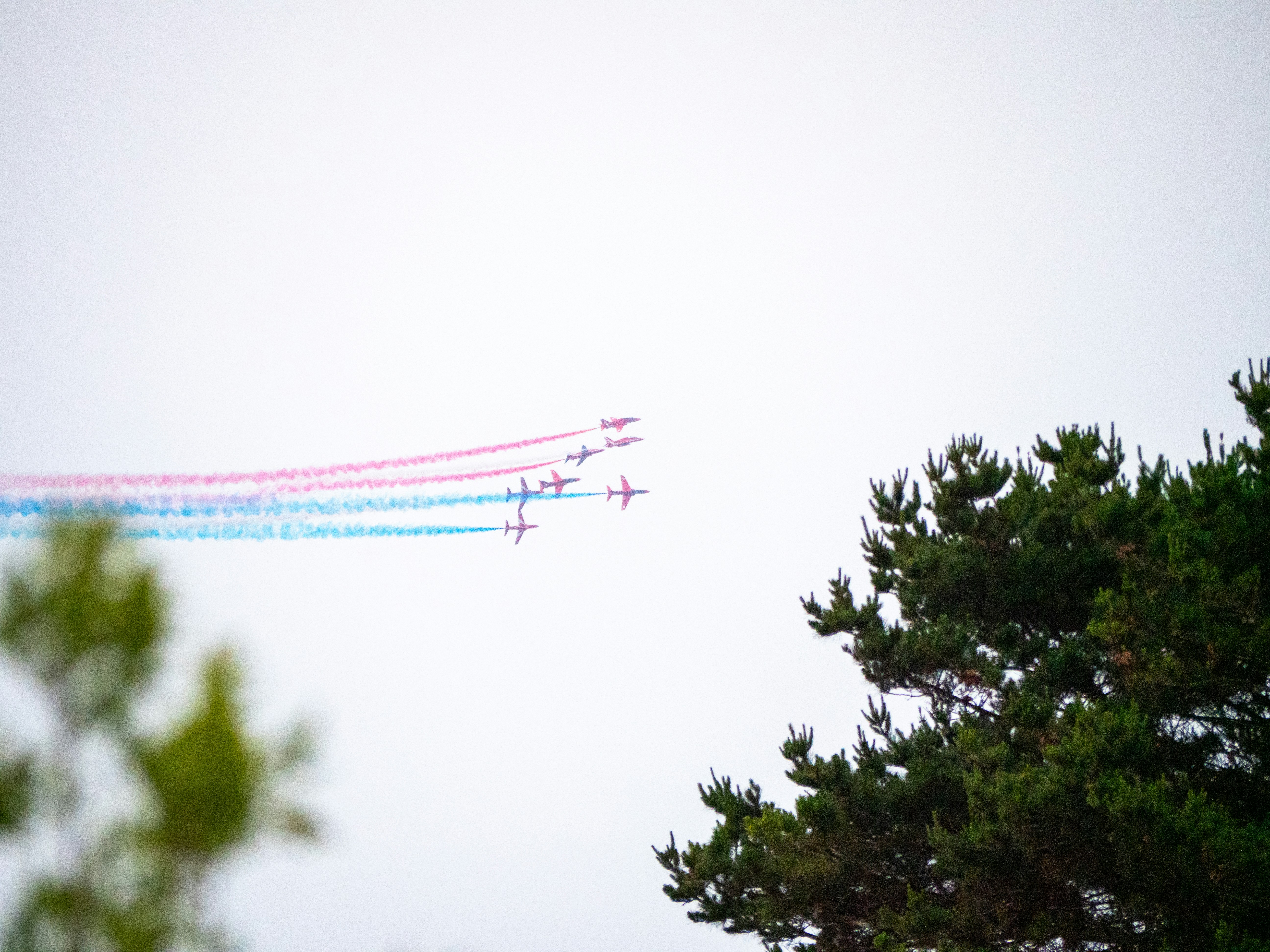 a group of airplanes flying through a cloudy sky