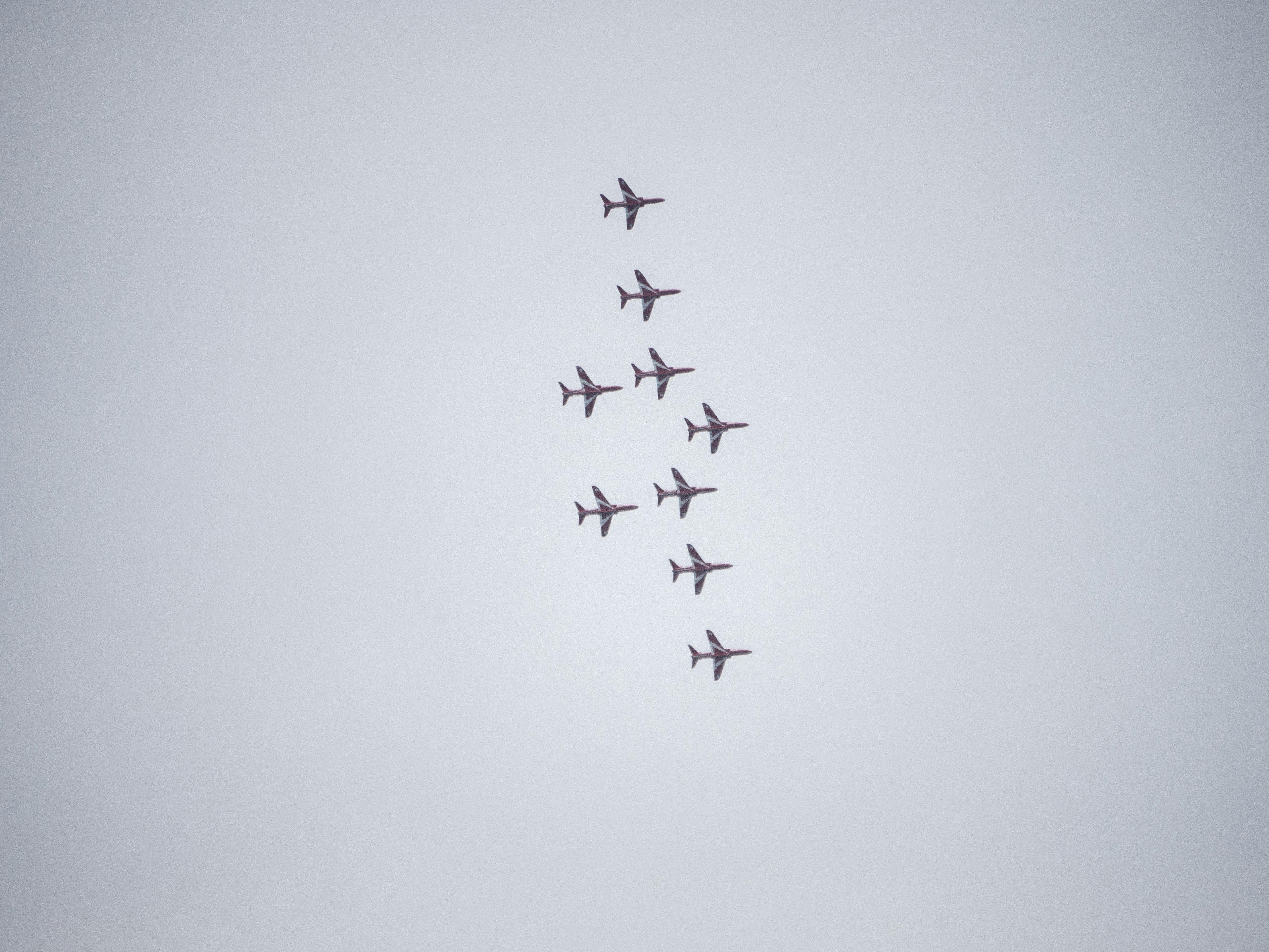 a group of planes flying in formation in the sky