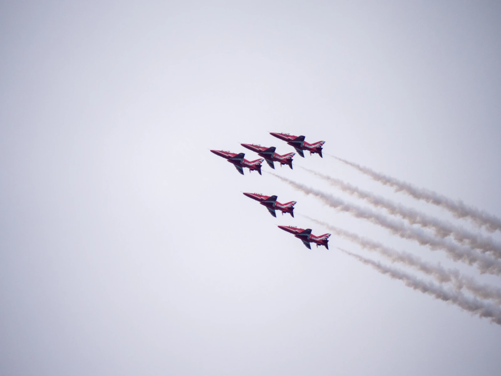 Fighter jets flying in formation through cloudy sky