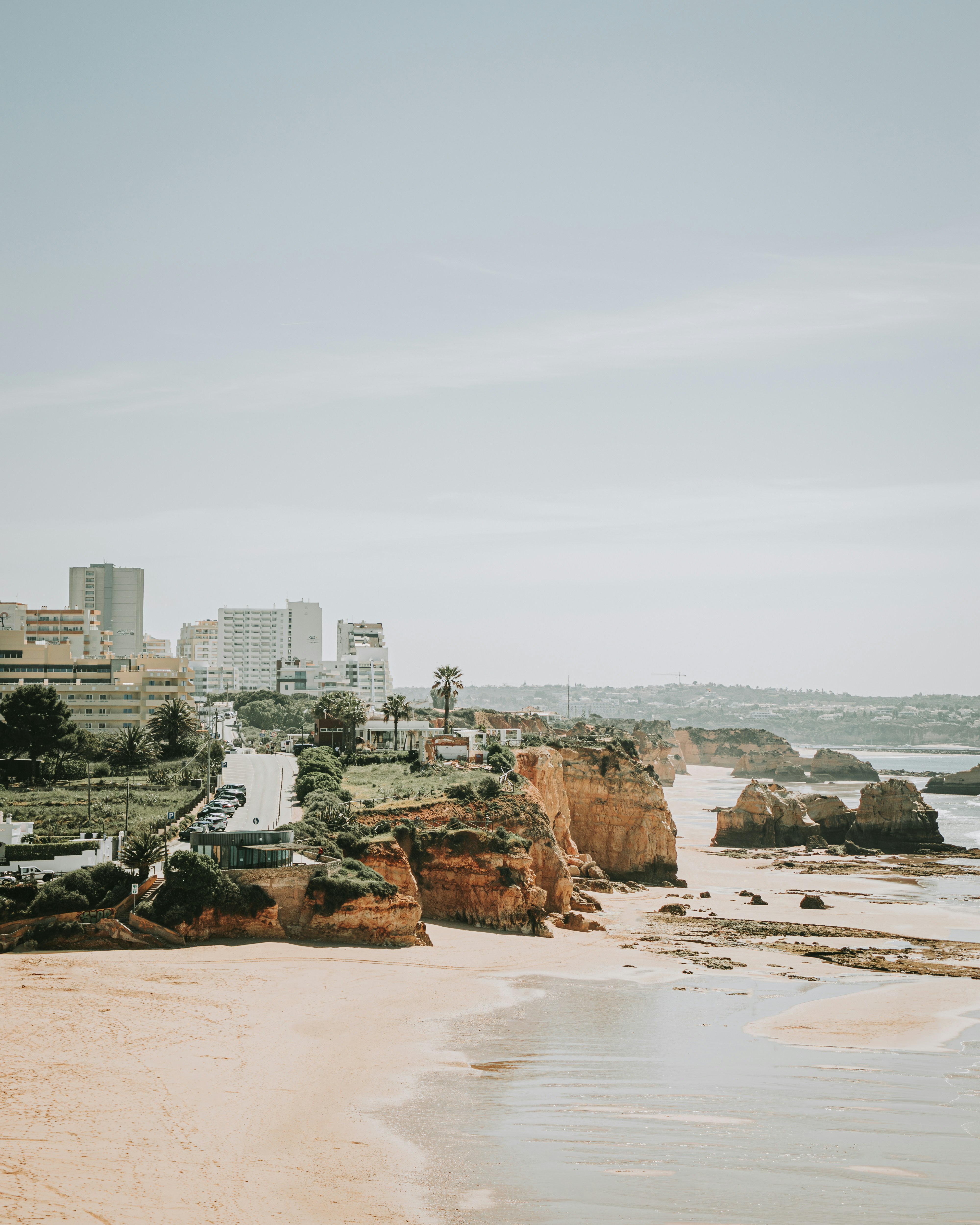 a view of a beach with a city in the background