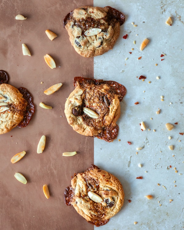 A table topped with cookies and almonds on top of a table