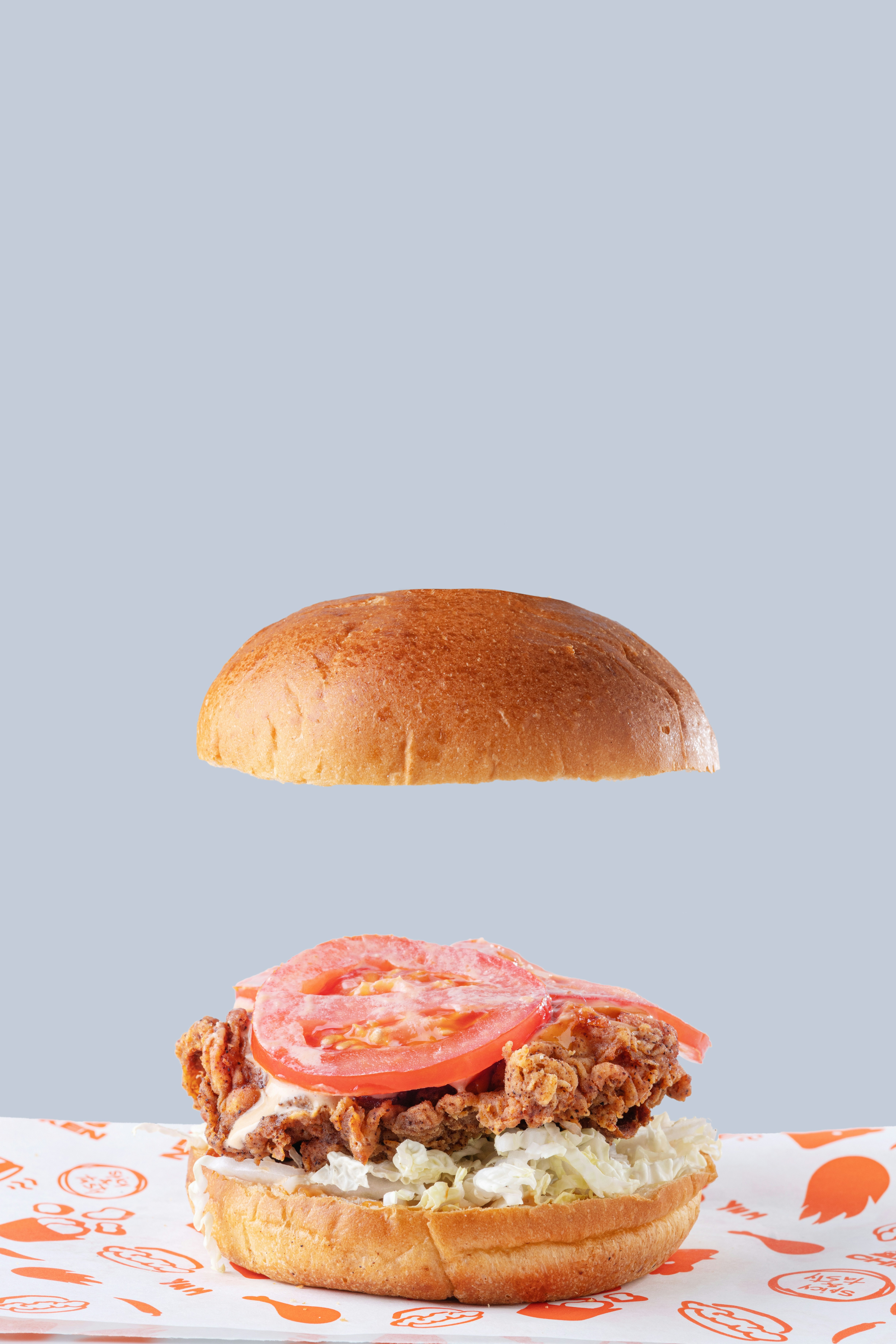 a sandwich with meat, tomato, and lettuce on a bun
