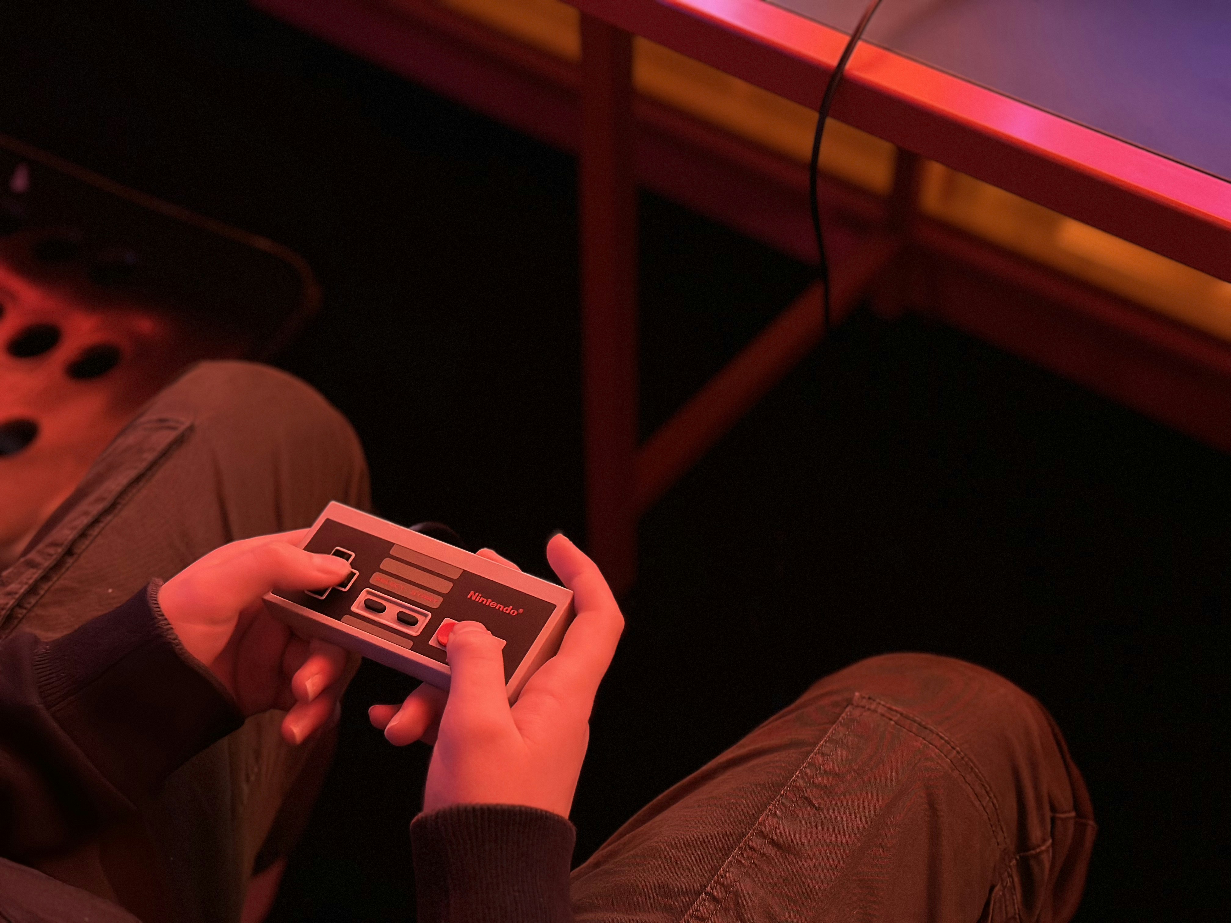 a person sitting on the floor playing a video game