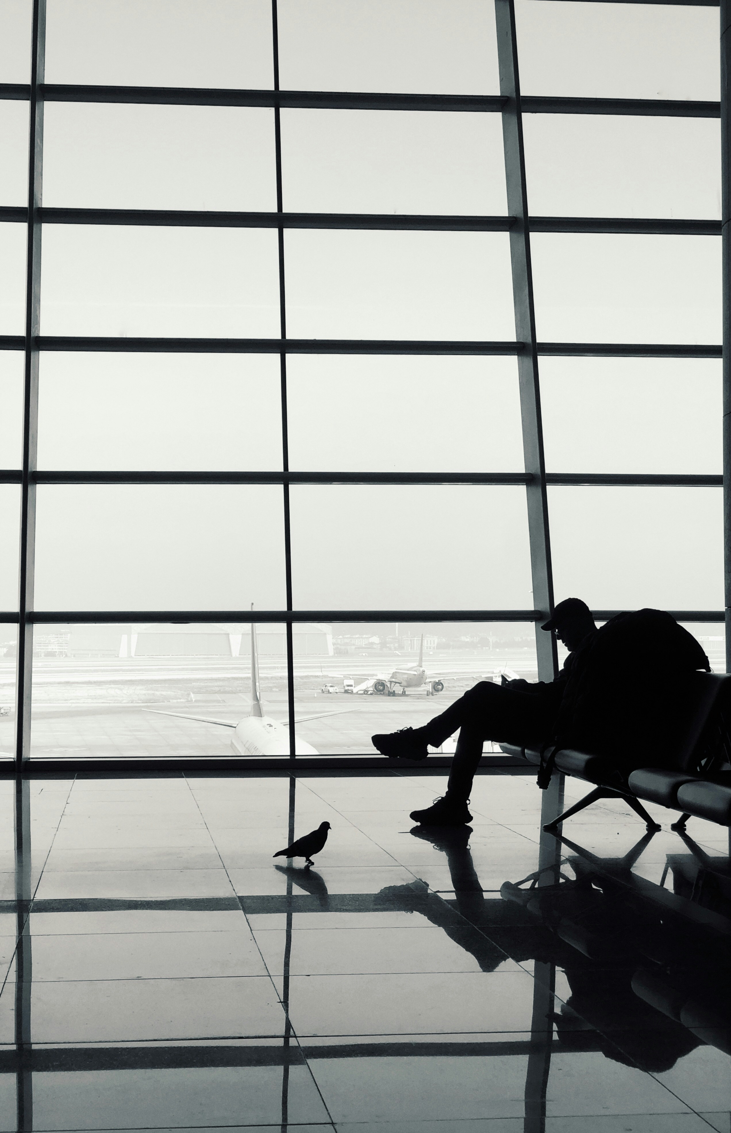 a man sitting on a bench in an airport