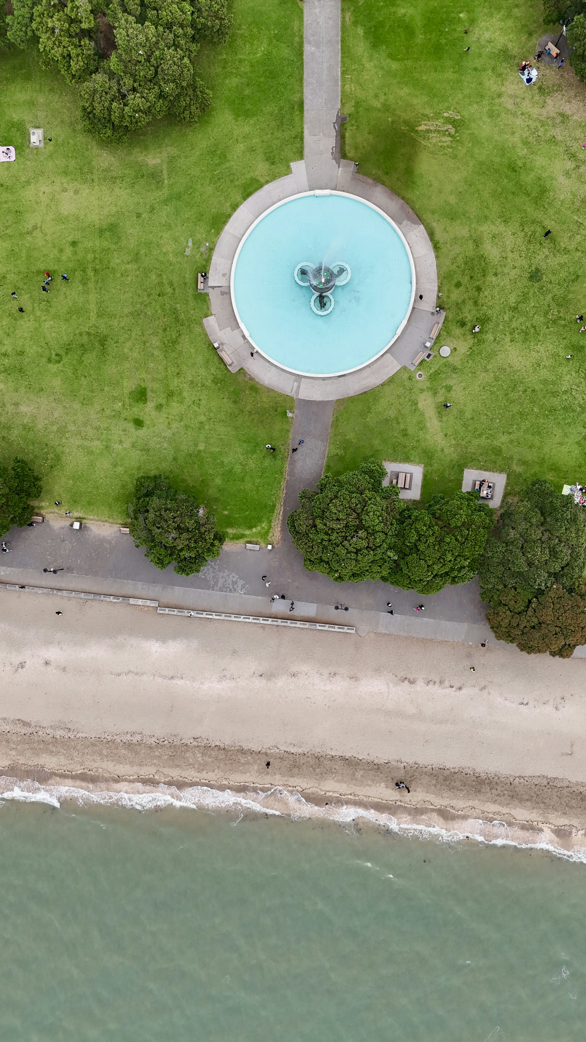 a bird's eye view of a water fountain in a park