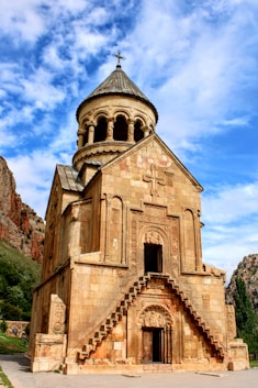 an old building with a steeple and a cross on top