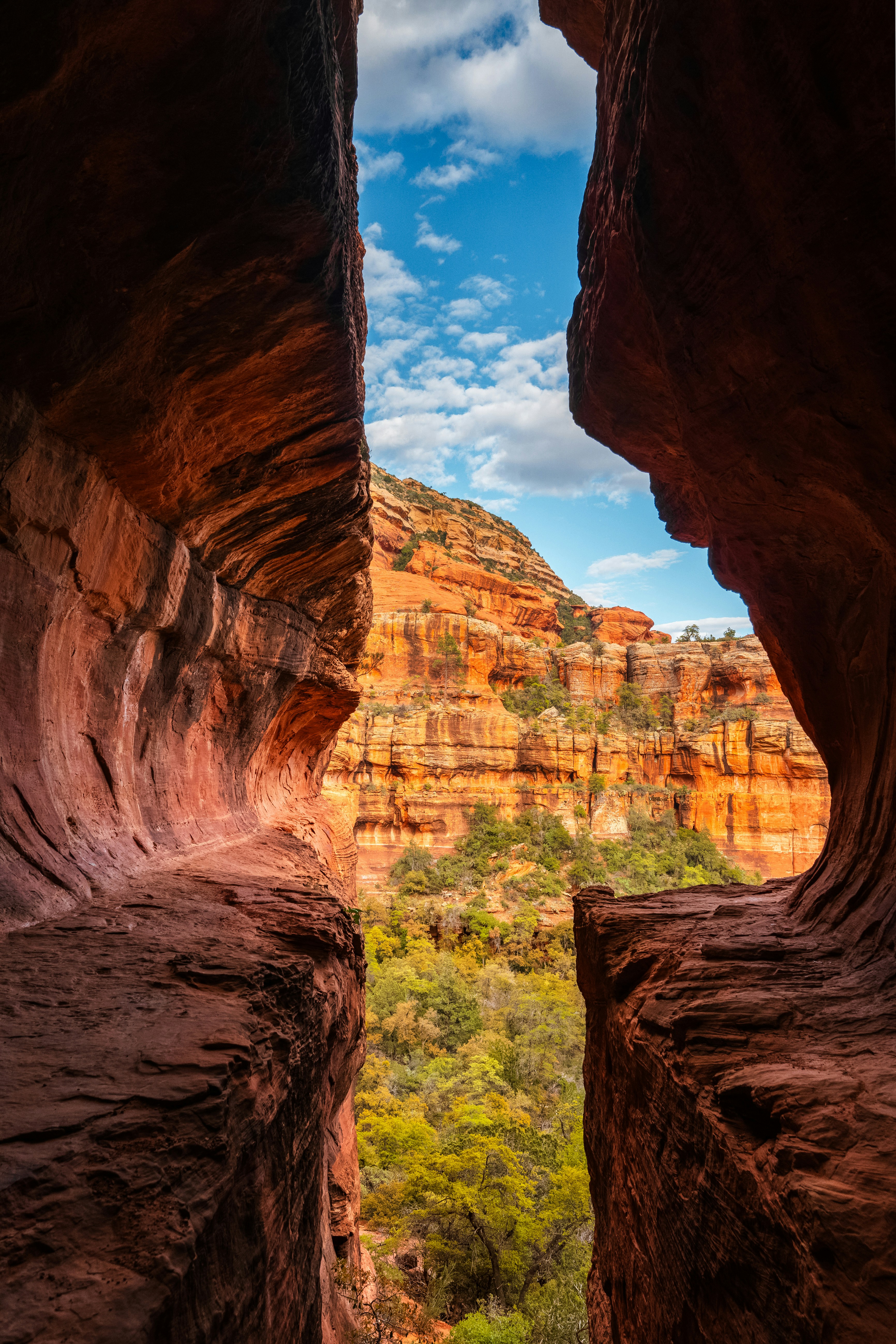 A view of a canyon from a window in a rock formation