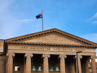 a building with pillars and a flag on top of it